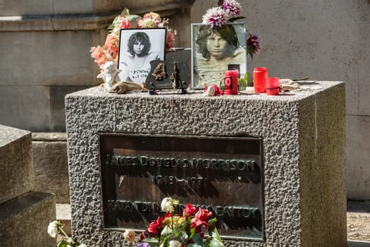 PARIS, FRANCE - SEPT 12, 2014:Jim Morrison grave in Pere-Lachaise cemetery, Paris. Each year thousands fans and curious visitors come to pay homage to Jim Morrison's grave