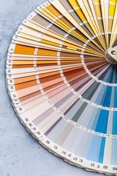 Industrial color palette guide of paint samples catalog on grey background, selective focus