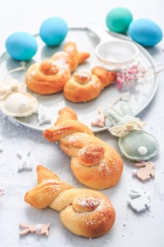 Easter baking - Buns made from yeast dough in a shape of Easter bunny and colored eggs