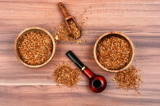 Fragrant smoking tobacco and a smoking tube or pipe on the table.