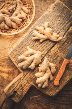 Fresh organic ginger roots on wooden background.