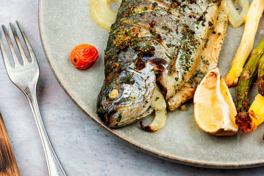 Grilled trout cooked with asparagus. Baked salmon fish on a plate. Healthy dinner