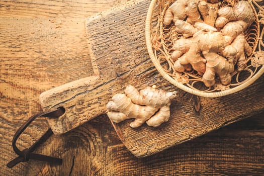 Fresh organic ginger roots on wooden background.