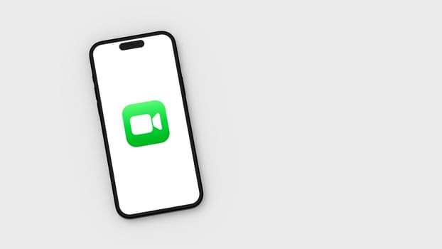 Facetime Logo on Mobile Phone Screen on Flat Light Gray Background with Copy Space 3D Render Illustration, Top View