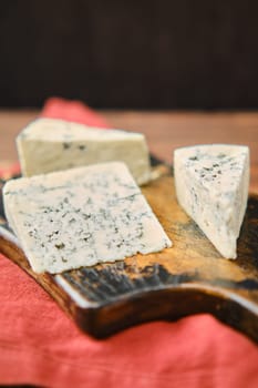 Closeup photo with shallow depth of field of different types of blue cheese