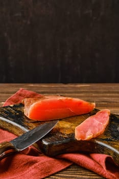 Air dried turkey breast on wooden cutting board with place for text