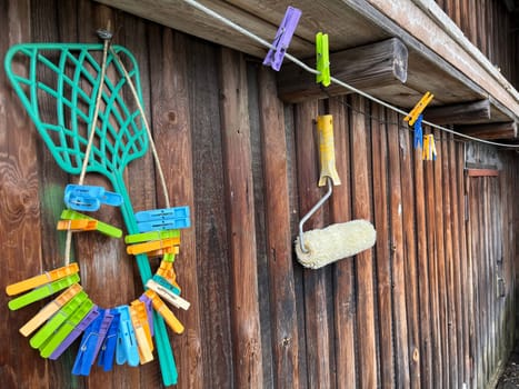 colorful clothespins hang on the wooden fence