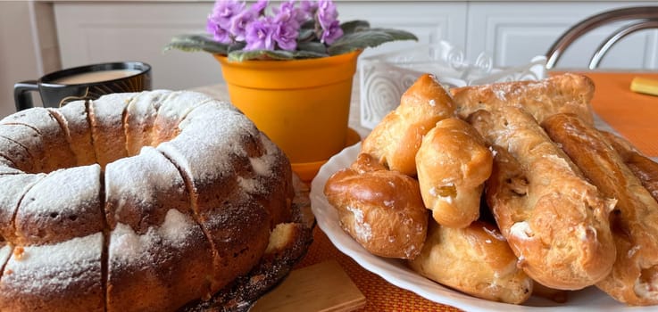 homemade cakes and a cup of coffee with milk on the table
