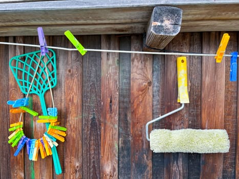 colorful clothespins hang on the wooden fence