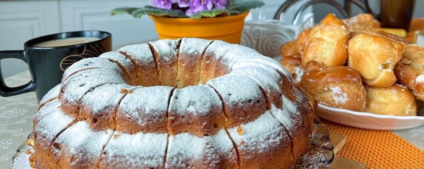 homemade cakes and a cup of coffee with milk on the table