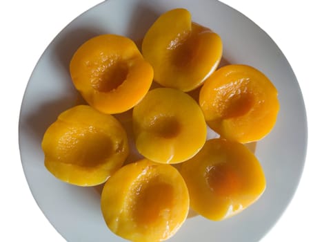 Plate of peaches halves in syrup. Isolated over white