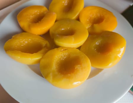Plate of peaches halves in syrup. Selective focus