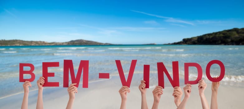 People Or Persons Hands Building Portuguese Word Bem-Vindo Means Welcome. Summer Ocean, Sea And Beach As Background.