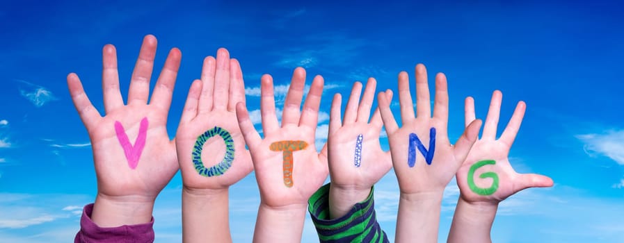 Children Hands Building Colorful English Word Voting. Blue Sky As Background