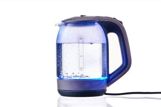 Glass electric kettle with boiling water on a white insulated background. High quality photo