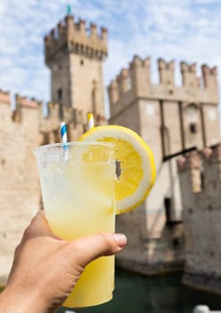 Hand with fresh cold lemonade. Concept for enjoy, relaxation, travel, summer