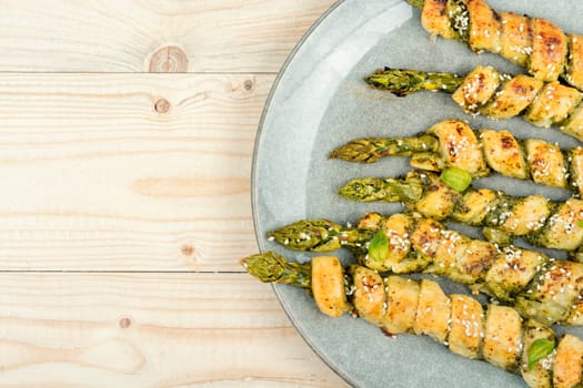 Asparagus baked in puff pastry with pesto sauce. Veggie food.