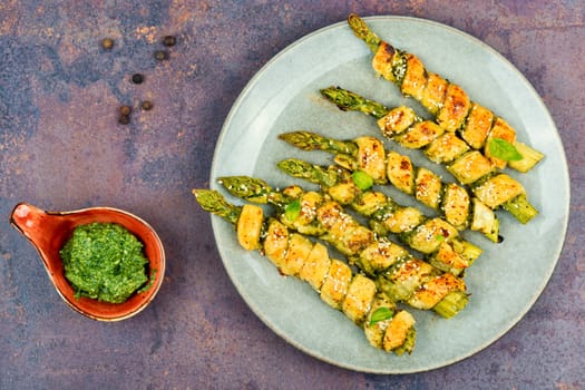 Asparagus baked in puff pastry with pesto sauce. Veggie food.
