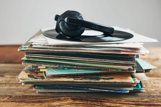 Stack of vinyl records. Listening to music from record. Playing music from analog disk. Retro and vintage. Audio stereo. Analog sound