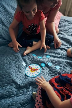 Kids learning how to tell time from clock and set the hands in the correct position. Teaching preschoolers tell time. Candid people, real moments, authentic situations