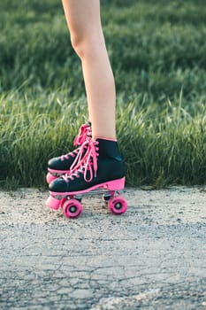Teenage girl having fun rollerskating, jumping, spending time on summer day