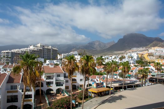 City of Costa Adeje in Spain on the Canary Island of Tenerife with mountains in the background
