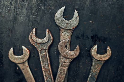 Spanners on steel surface. Old rusty wrenches for maintenance. Mechanic hardware tools to fix. Technical tools background with copy space