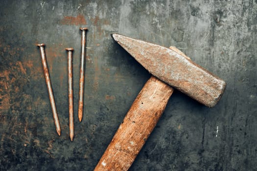 Hammer and nails on steel surface. Tools for maintenance. Hardware tools to fix. Technical background with copy space