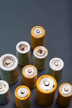 Discharged batteries on paper background. Collecting used batteries to recycle. Waste disposal and recycling. Copy space for text