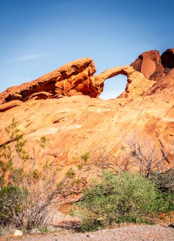 Moon rising over Arch Rock formation in Valley of Fire State Park in Nevada