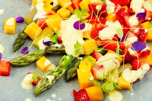 Summer salad with spice, strawberries, yogurt and mango.