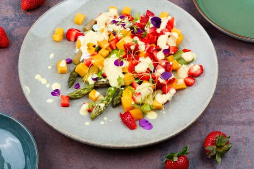 Summer salad with spice, strawberries, yogurt and mango.