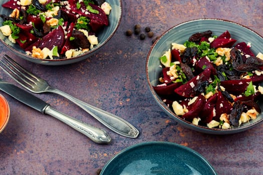 Diet salad of beets, nuts and cheese on the plate.