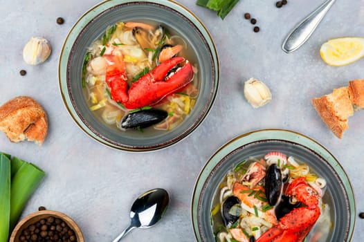 Tasty soup with lobster, mussels, shrimps and fish. Seafood soup. Copy space