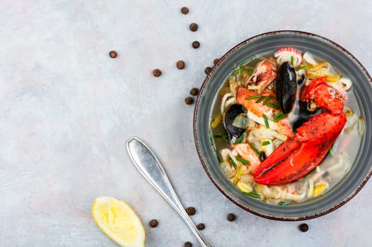 Tasty soup with lobster, mussels, shrimps and fish. Seafood soup. Copy space