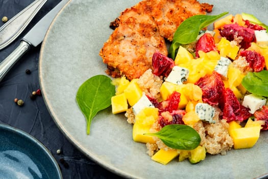 Salad with fruit, chicken breast,cheese and quinoa. Healthy food