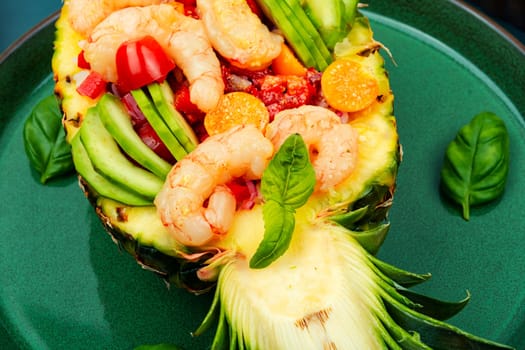 Delicious pineapple stuffed with vegetables, rice, avocado and shrimps. Peruvian food