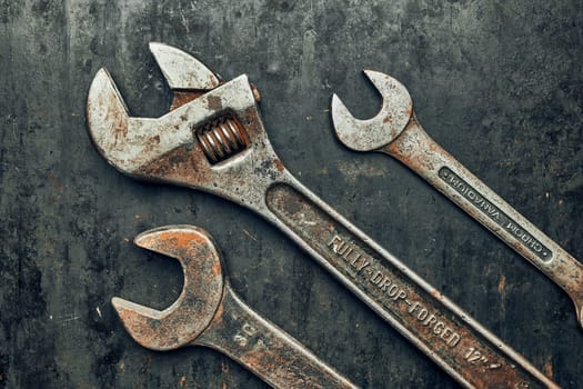 Spanners on steel surface. Old rusty wrenches for maintenance. Mechanic hardware tools to fix. Technical tools background with copy space