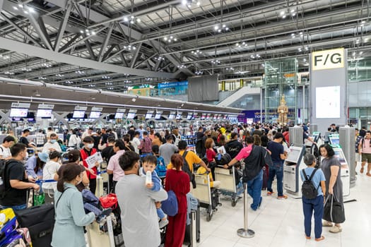 Bangkok, Thailand - April 10, 2023: Suvarnabhumi Airport with many travelers during the Songkran Festival because it is the Thai New Year which is a long holiday.There are many festivals in provinces.