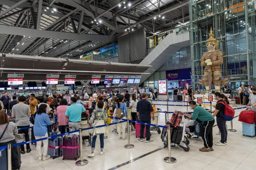 Bangkok, Thailand - April 10, 2023: Suvarnabhumi Airport with many travelers during the Songkran Festival because it is the Thai New Year which is a long holiday.There are many festivals in provinces.