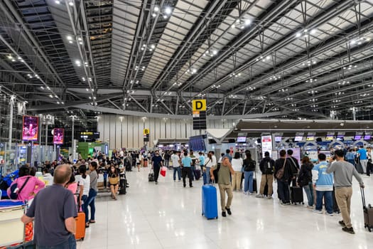 Bangkok, Thailand - April 10, 2023: Suvarnabhumi Airport with many travelers during the Songkran Festival because it is the Thai New Year which is a long holiday.There are many festivals in provinces.