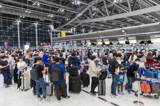 Bangkok, Thailand - April 10, 2023: Suvarnabhumi Airport with many travelers during the Songkran Festival because it is the Thai New Year which is a long holiday.There are many festivals in provinces.