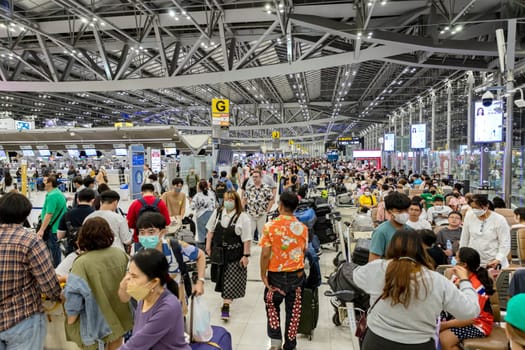 Bangkok, Thailand - April 10, 2023: Suvarnabhumi Airport with many travelers during the Songkran Festival because it is the Thai New Year which is a long holiday.There are many festivals in provinces.