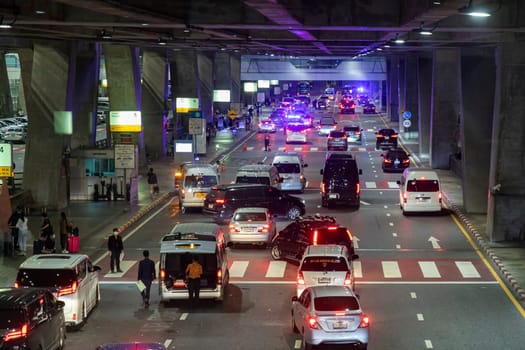 Bangkok, Thailand - April 10, 2023: Nighttime traffic jam on the road in front of Suvarnabhumi Airport during Songkran Festival, Thailand's New Year. Both Thai and foreign tourists travel a lot.
