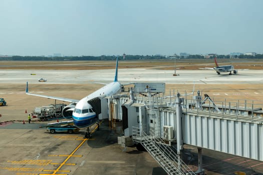 Ho Chi Minh / Vietnam - March 30, 2019: China Southern Airlines flight is loading in Ho Chi Minh Airport for its next flight and another far away flight is preparing to fly
