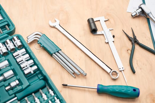 Workshop table with many tools. Wrench, spanner, calliper and ratchet with many attachments. Work tools. Universal tool set. Professional equipment. Background
