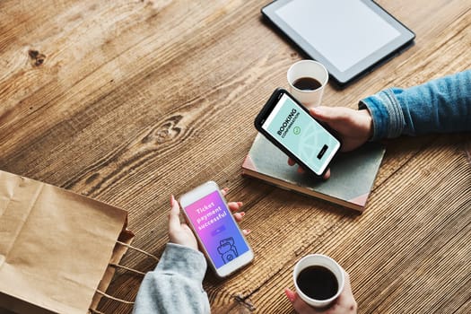 Online shopping. Booking online. Buying tickets online. Ordering product in online shop using smartphone. Order confirmation on screen. Online banking. People paying online. Paying for online shopping while charging mobile phone from powerbank in coffee shop