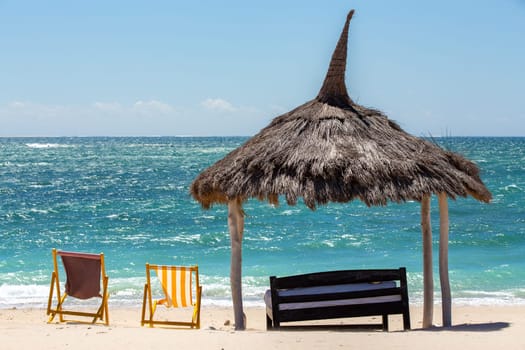 Tranquil and beautiful day on Anakao beach in Madagascar, with a clear blue sky, a comfortable sun lounger, and a colorful parasol for your ultimate relaxation. Toliara, Madagascar