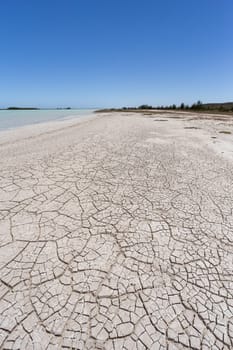 Stunning view of Tsimanampetsotsa Lake with dry, cracked beach and surrounding landscape with blue sky. Madagascar wilderness landscape