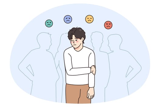 Sad guy feel lonely and uncomfortable in society. Unhappy young man suffer from solitude and loneliness in crowd, have various emotions. Frustration and depression. Vector illustration.